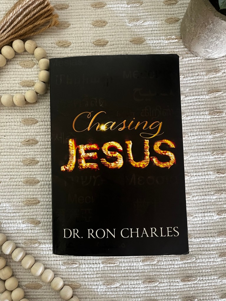 Chasing Jesus by Dr. Ron Charles on a cream textured blanket with wooden beads
